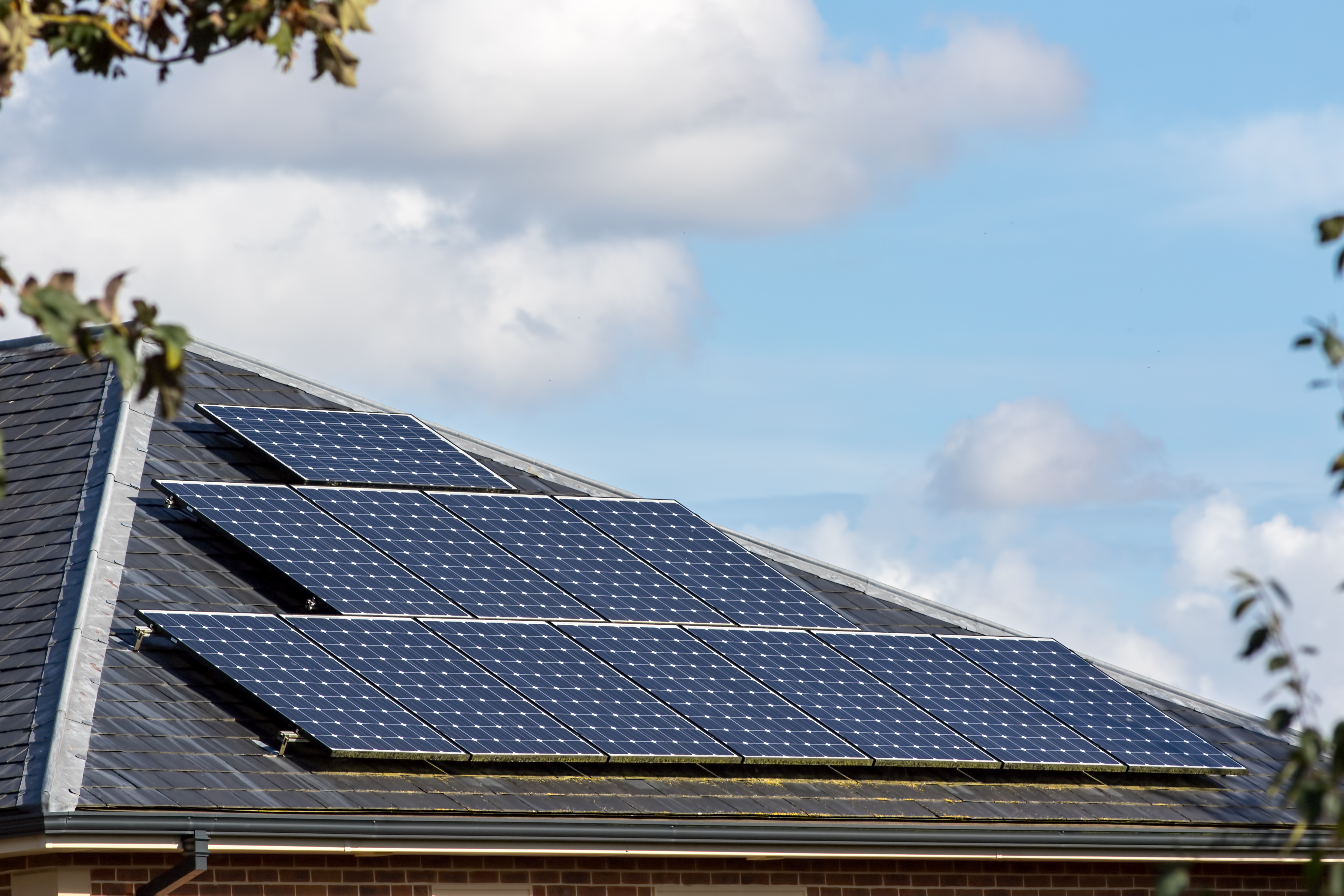 Solar panels on slate tiled roof of modern house