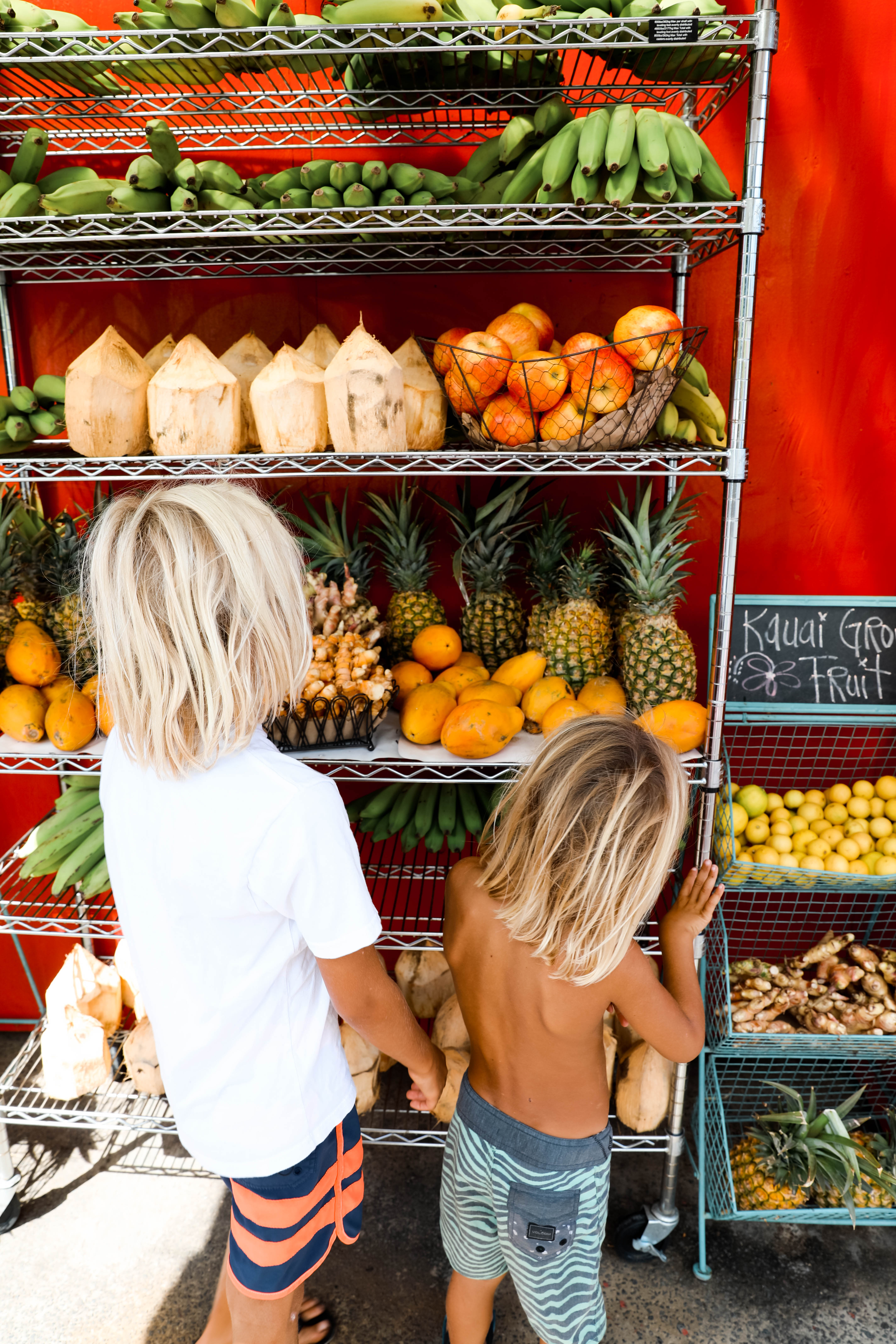 kids looking at fruit on fruit stand