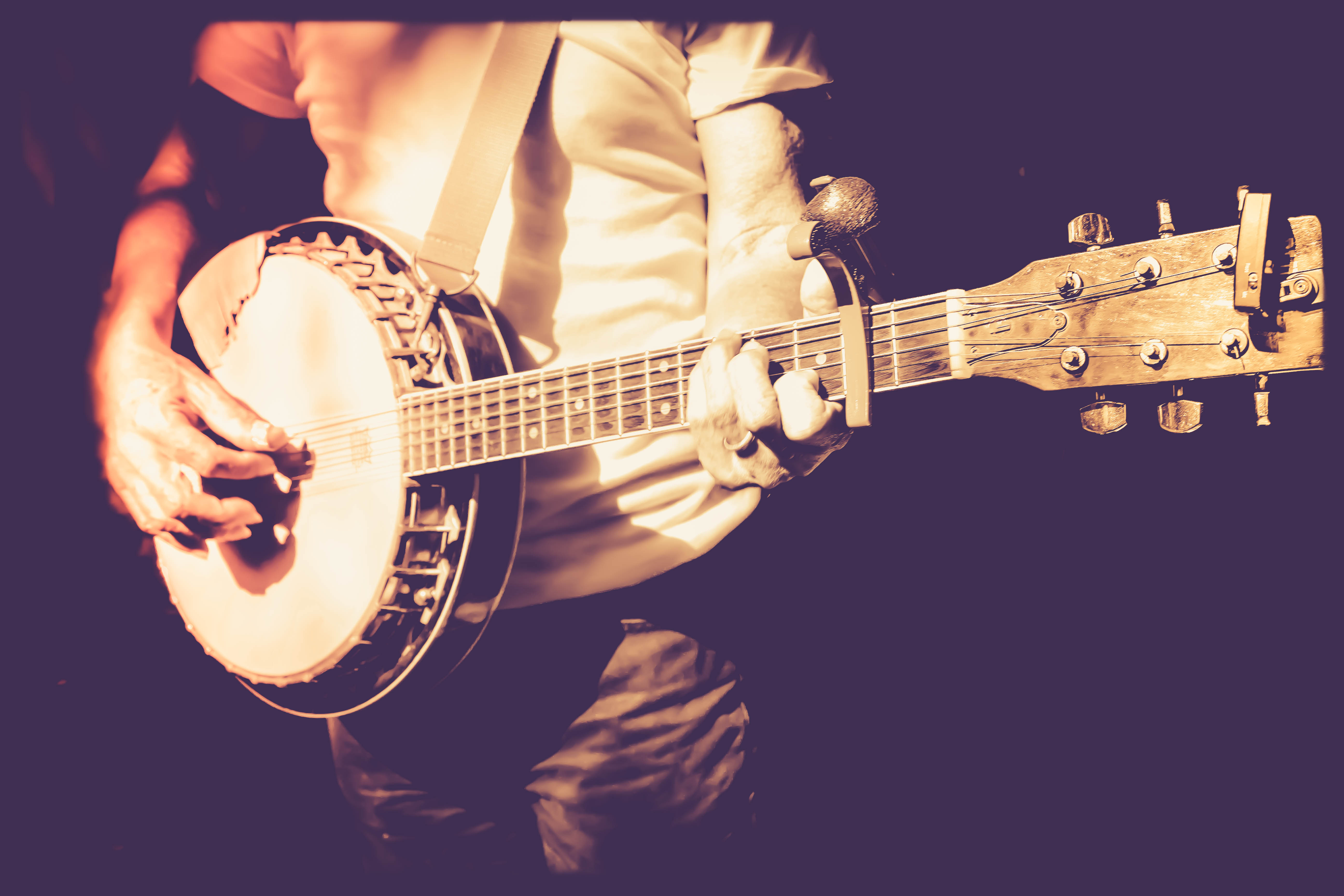 musician playing banjo in retro filter photo