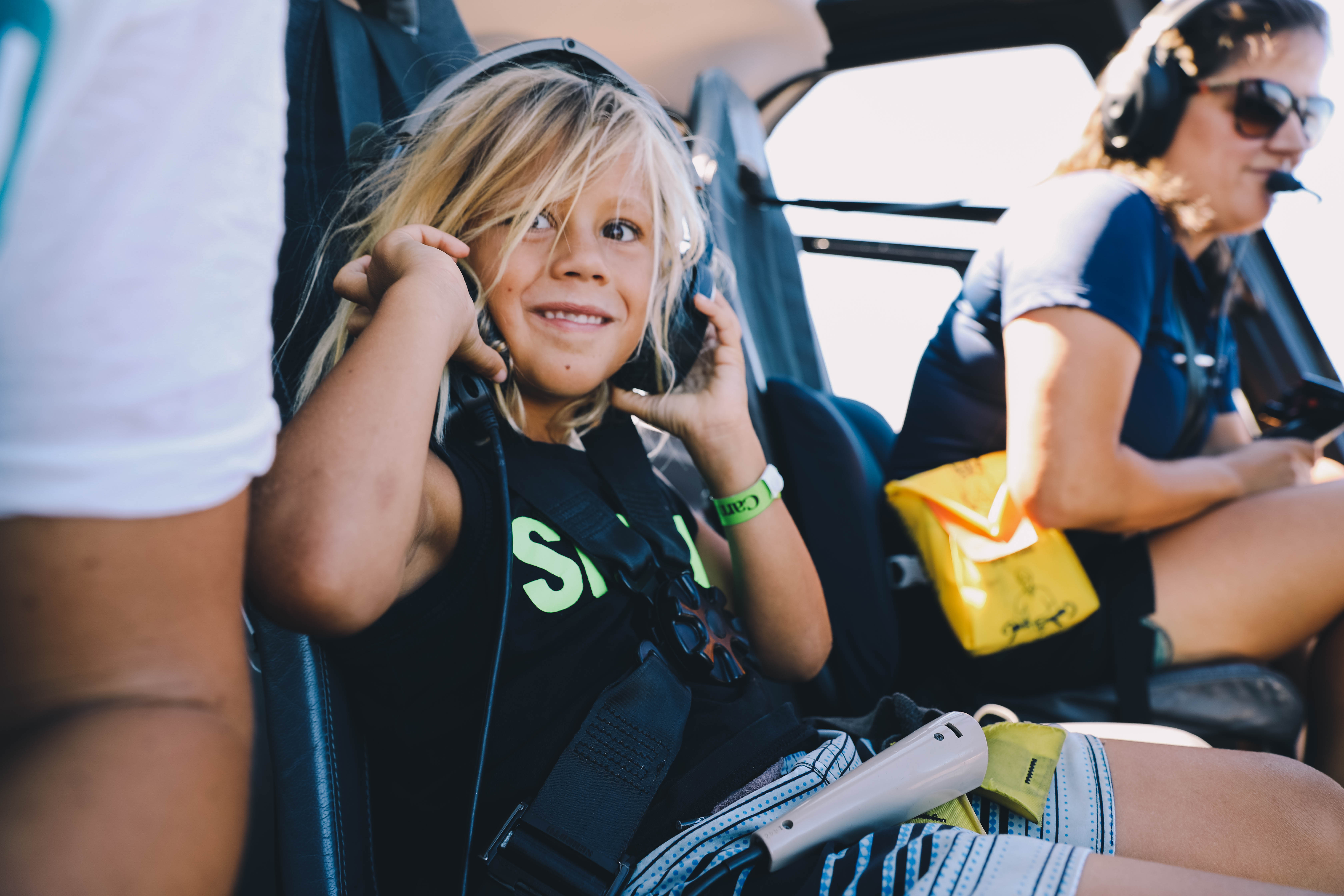 boy with headset on in helicopter