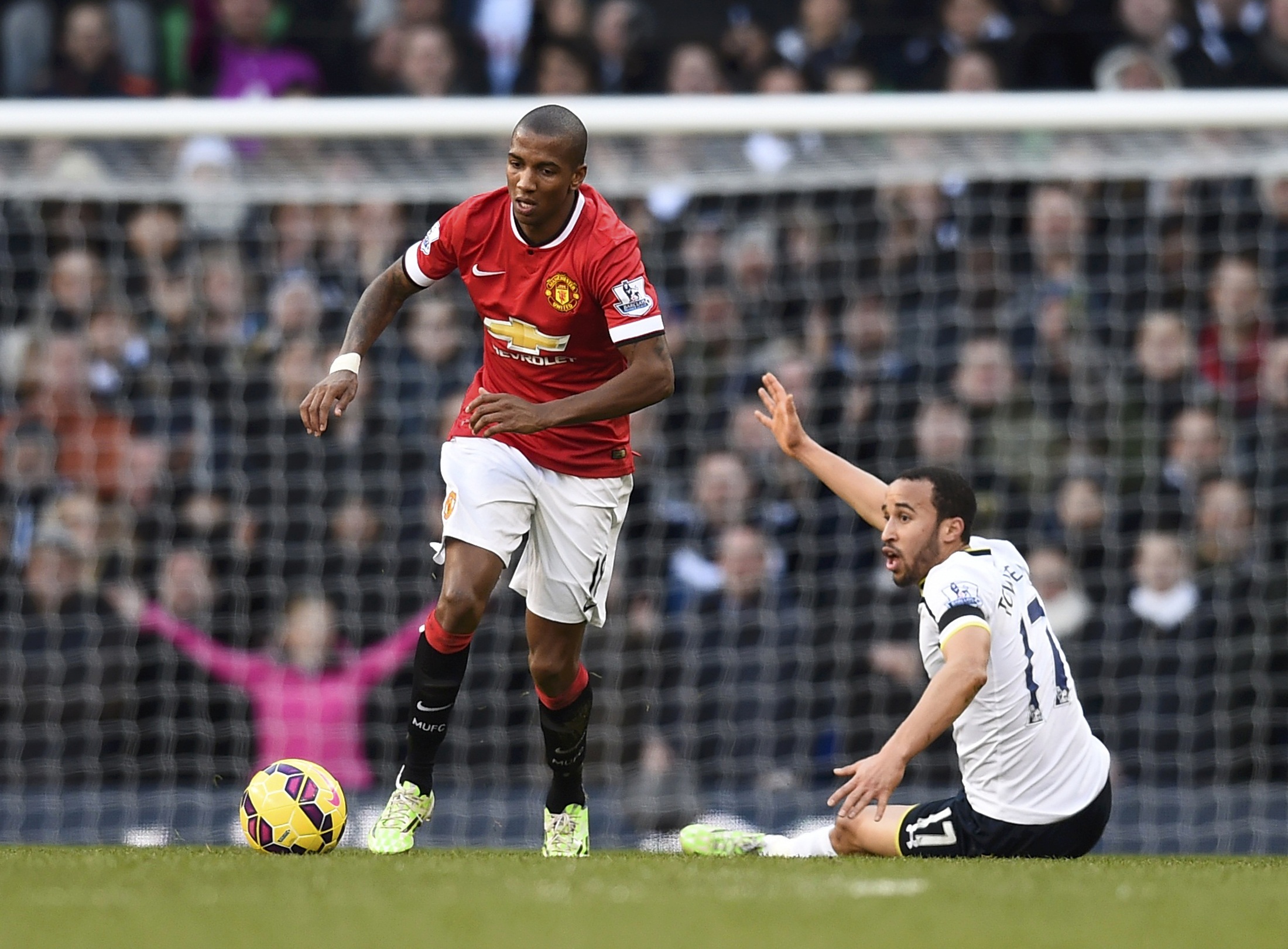 Manchester United's Ashley Young runs past Tottenham Hotspur's Andros Townsend during their English Premier League soccer match at White Hart Lane in London